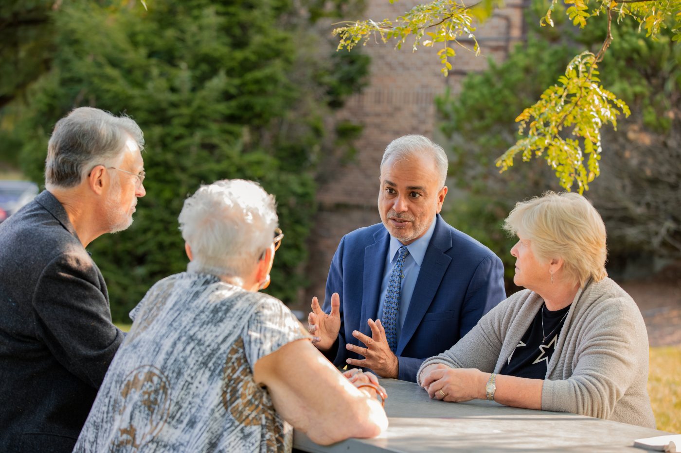 Dr. Saud Anwar talking with a group of seniors