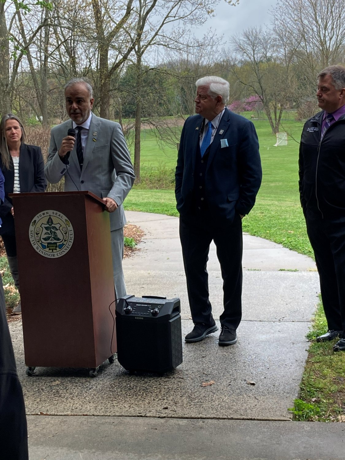 Dr. Saud Anwar speaking at a South Windsor town podium