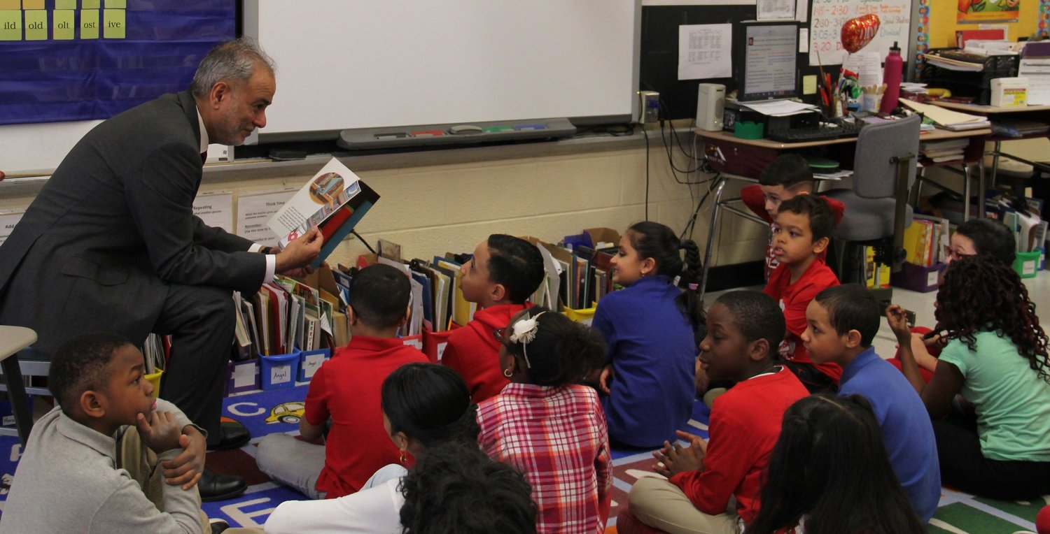Dr. Saud Anwar reading to elementary-school students